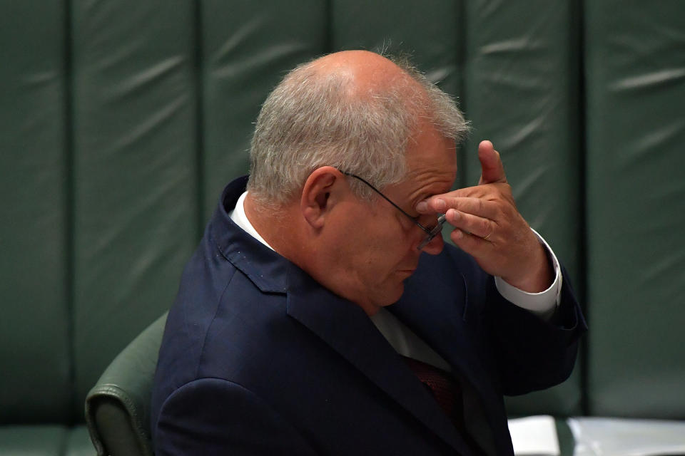 CANBERRA, AUSTRALIA - FEBRUARY 03: Prime Minister Scott Morrison reacts during Question Time in the House of Representatives on February 03, 2021 in Canberra, Australia. Liberal MP Craig Kelly has been told by the Prime Minister Scott Morrison to heed expert medical advice, after the outspoken politician promoted unproven coronavirus treatments and questioned the safety of vaccinations. (Photo by Sam Mooy/Getty Images)