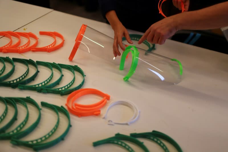 Technical staff members display 3D printed protective visors made for healthcare professionals, amid the coronavirus disease (COVID-19) outbreak, at the Casa Firjan FabLab in Rio de Janeiro