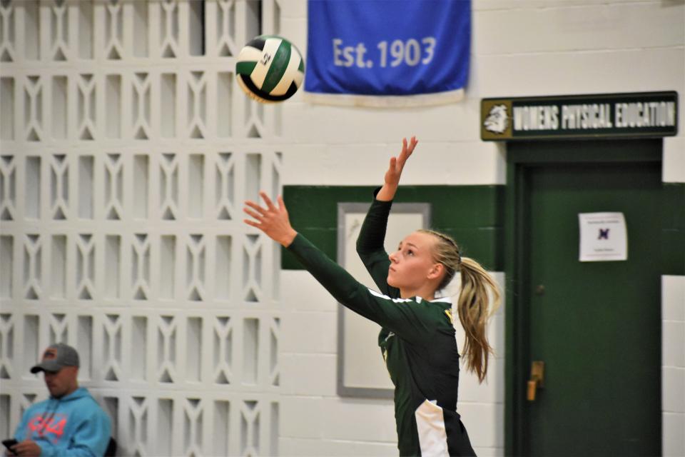 Monrovia's Raegan Stader tosses the ball up for a serve during the Bulldogs' matchup with Martinsville on Aug. 25, 2022