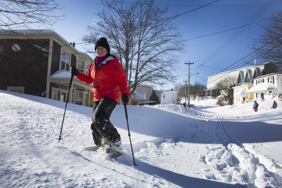 Tracey Boland snowshoes in the middle of a major street, in downtown St. John's, NL on Saturday, January 18, 2020. he state of emergency ordered by the City of St. John's is still in place, leaving businesses closed and vehicles off the roads in the aftermath of the major winter storm that hit the Newfoundland and Labrador capital. THE CANADIAN PRESS/Paul Daly