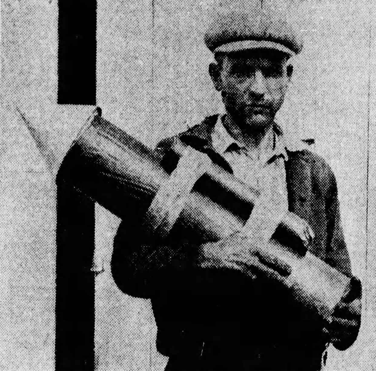 Hudson fireworks maker Jim Sorgi, 43, holds a 50-pound model of the rocket he planned to send to the moon in 1929.