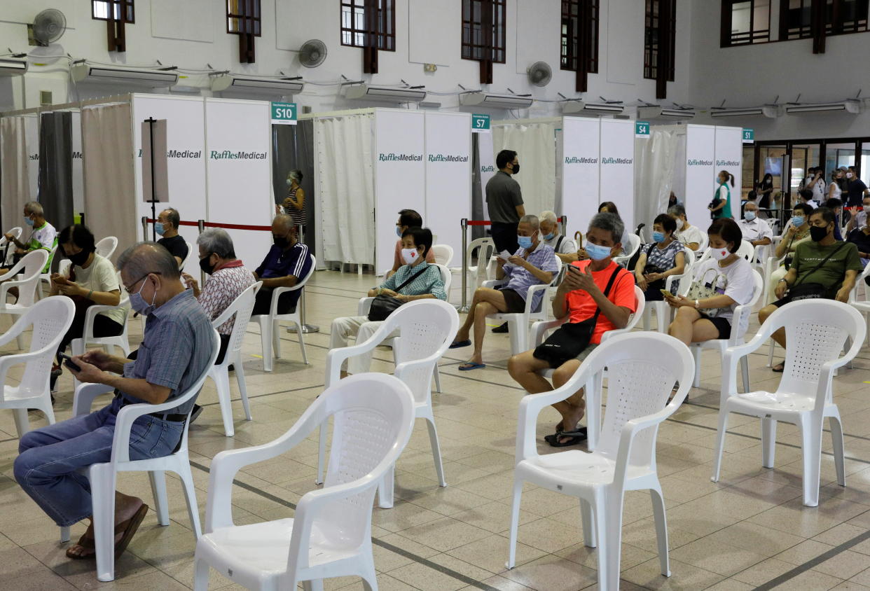 People above 70 years old wait in an observation area after getting a dose of the coronavirus disease (COVID-19) vaccine at a vaccination center in Singapore January 27, 2021. REUTERS/Edgar Su