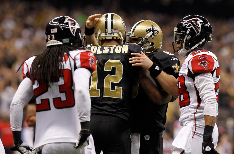 NEW ORLEANS, LA - DECEMBER 26: Wide receiver Marques Colston #12 of the New Orleans Saints celebrates with quarterback Drew Brees #9 after Colston catches an eight-yard touchdown pass in the second quarter against the Atlanta Falcons at the Mercedes-Benz Superdome on December 26, 2011 in New Orleans, Louisiana. (Photo by Chris Graythen/Getty Images)