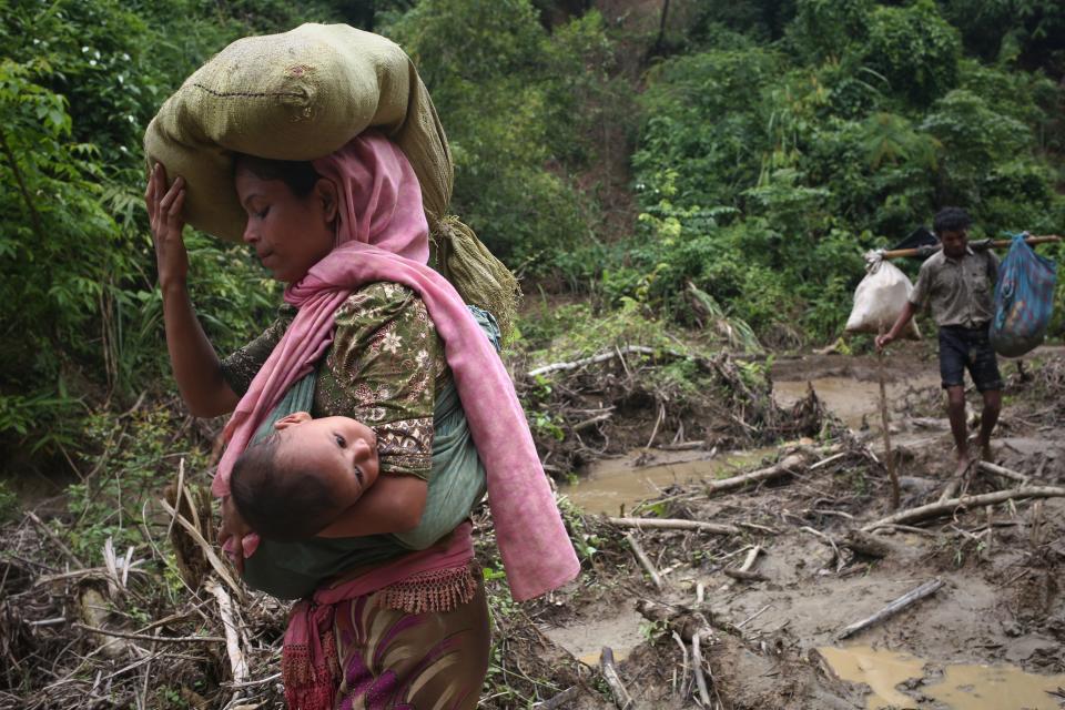 A Rohingya woman carries her child in a sling after crossing the border into Bangladesh on Sept. 5, 2017. (Photo: Mushfiqul Alam/NurPhoto via Getty Images)