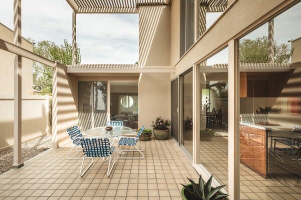 A partially covered, double-height courtyard offers an idyllic setting for al fresco dining.