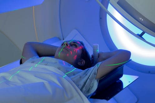 <span class="caption">Radiotherapy tattoos help ensure a patient is properly placed beneath the machine.</span> <span class="attribution"><a class="link " href="https://www.shutterstock.com/image-photo/young-woman-receiving-radiation-therapy-treatments-1095820514" rel="nofollow noopener" target="_blank" data-ylk="slk:Mark_Kostich/ Shutterstock;elm:context_link;itc:0;sec:content-canvas">Mark_Kostich/ Shutterstock</a></span>