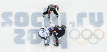 Finland forward Mikael Grandlund and USA forward David Backes face off to start the men's bronze medal ice hockey game at the 2014 Winter Olympics, Saturday, Feb. 22, 2014, in Sochi, Russia. (AP Photo/David J. Phillip )