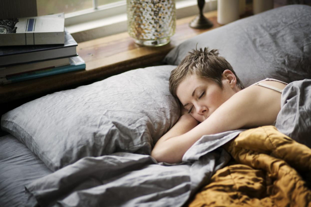 Woman sleeping in bed at home