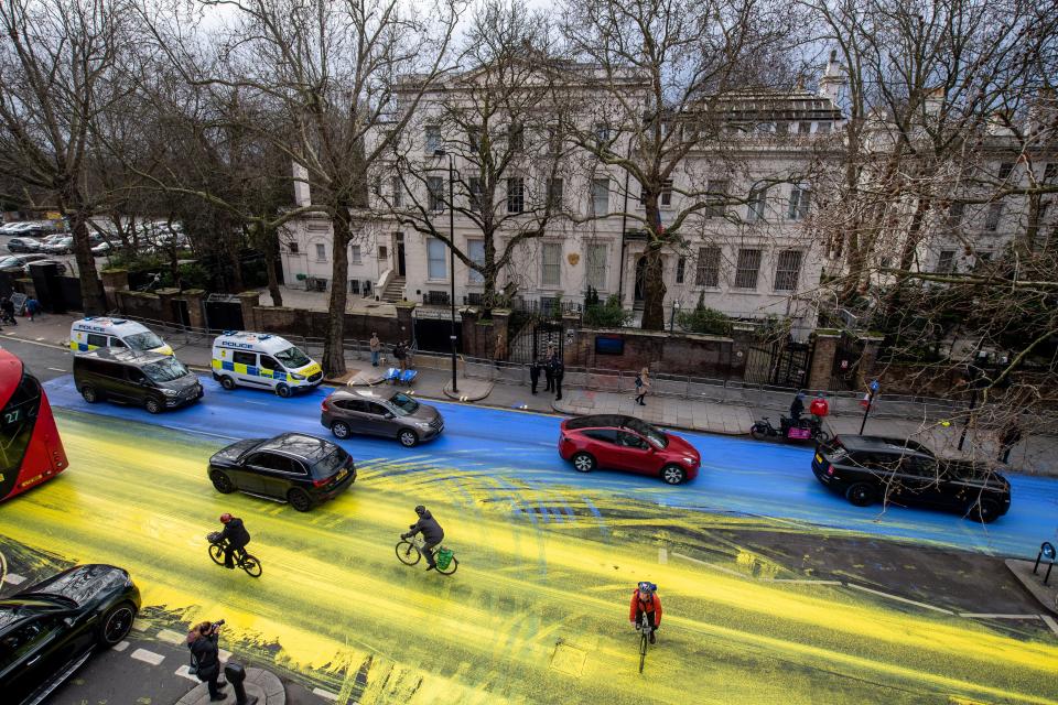 In this handout provided by Led By Donkeys, activists in London pour paint onto the road to create a giant Ukrainian flag outside the Russian Embassy on Feb., 2023.