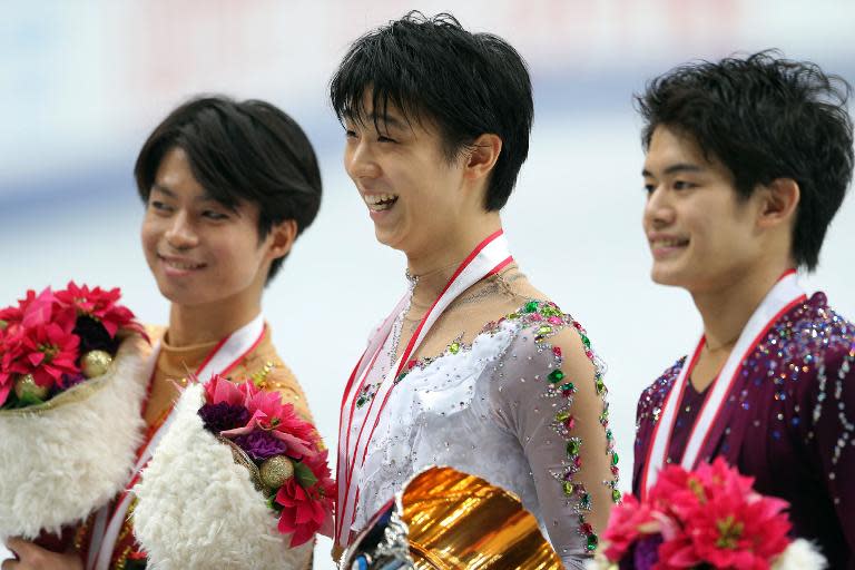 Yuzuru Hanyu (C), pictured after winning gold, Tatsuki Machida (L) after winning silver and Takahiko Kozuka after winning bronze in the men's single skating at Japan's national championships in Saitama, suburban Tokyo, on December 22, 2013