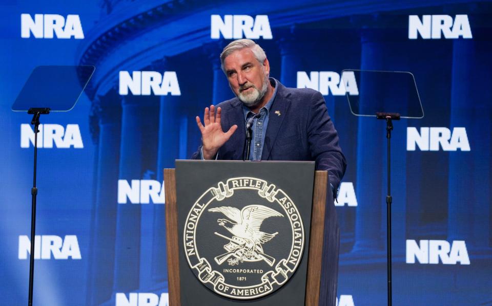 Indiana Gov. Eric Holcomb speaks Friday, April 14, 2023, during the NRA convention at the Indiana Convention Center in Indianapolis.
