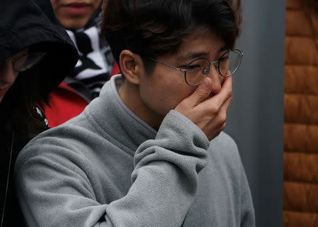 A mourner reacts at a makeshift memorial a day after a van struck multiple people along a major intersection in north Toronto, Ontario, Canada, April 24, 2018. REUTERS/Carlo Allegri