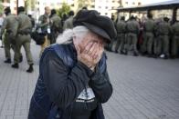 An elderly woman reacts as police officers detain women during an opposition rally to protest the official presidential election results in Minsk, Belarus, Saturday, Sept. 19, 2020. Daily protests calling for the authoritarian president's resignation are now in their second month and opposition determination appears strong despite the detention of protest leaders. (AP Photo/TUT.by)