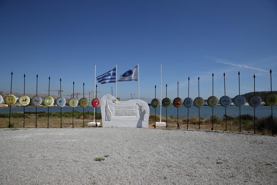 Signs on shields, referring to ships which took part in the naval Battle of Salamis from various places of ancient Greece, are seen on Salamina island, west of Athens, on Monday, Aug. 26, 2019. Greece this year is commemorating one of the greatest naval battles in ancient history at Salamis, where the invading Persian navy suffered a heavy defeat 2,500 years ago. But before the celebrations can start in earnest, authorities and private donors are leaning into a massive decluttering operation. They are clearing the coastline of dozens of sunken and partially sunken cargo ships, sailboats and other abandoned vessels. (AP Photo/Thanassis Stavrakis)