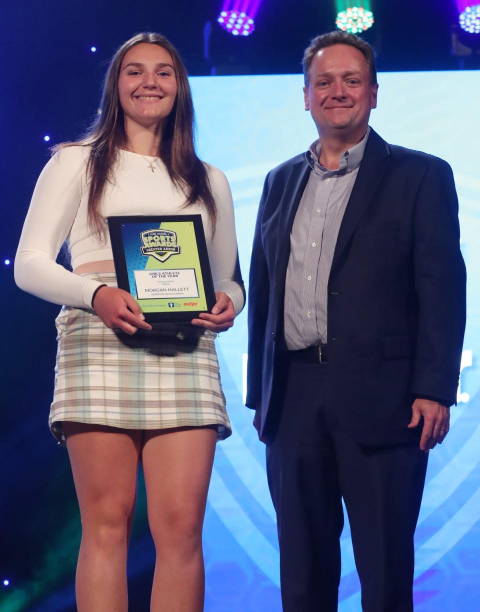 Norton High School's Morgan Hallett Greater Akron Female Athlete of the Year poses with Beacon Journal editor Michael Shearer at the High School Sports All-Star Awards at the Civic Theatre in Akron on Friday.