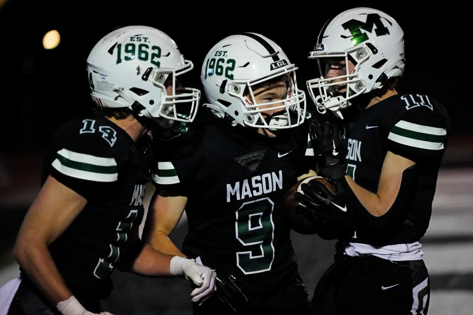 Mason receiver Colin Billhorn (9) celebrates after catching a pass for a game-tying touchdown in the third quarter of the first OHSAA DIV I playoff game between the Mason and Colerain. Mason advances to play Springboro after a 14-7 win at home.