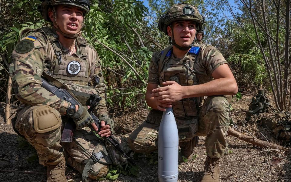 Ukrainian servicemen of the National Guard of Ukraine prepare a shell for a D-30 howitzer at a position at a front line