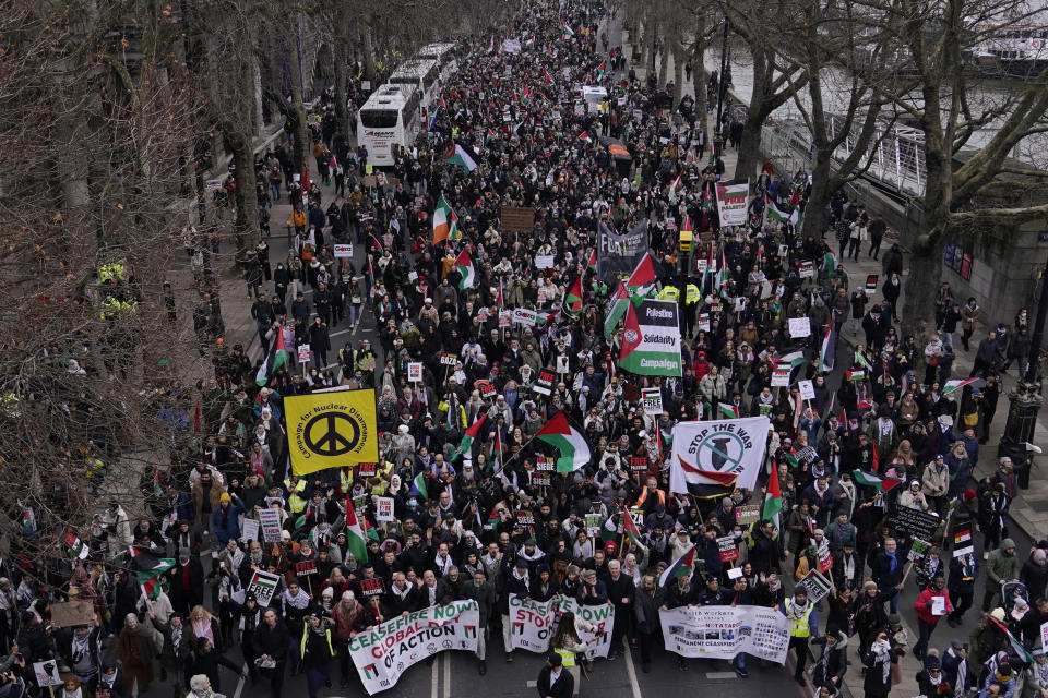 Protesters hold up banners, flags and placards as they walk along the Embankment by the River Thames during a demonstration in support of Palestinian people in Gaza, in London, Saturday, Jan. 13, 2024.(AP Photo/Alberto Pezzali)