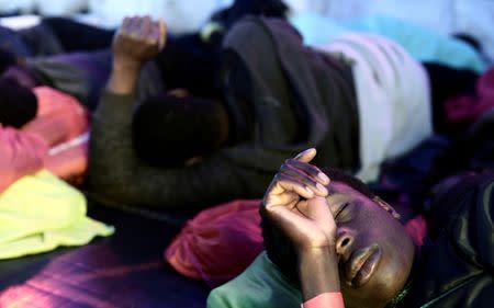 Migrants rest on the deck of MV Aquarius, a search and rescue ship run in partnership between SOS Mediterranee and Medecins Sans Frontieres on their way to Spain, June 13, 2018. Karpov / SOS Mediterranee/handout via REUTERS