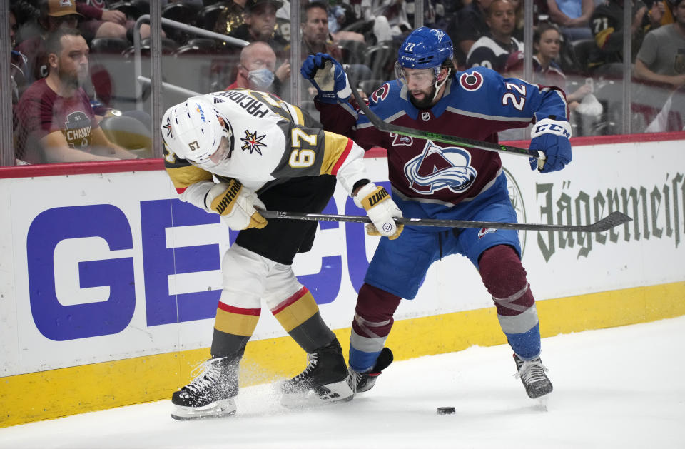 Vegas Golden Knights left wing Max Pacioretty, left, fights for control of the puck with Colorado Avalanche defenseman Conor Timmins during the first period of Game 5 of an NHL hockey Stanley Cup second-round playoff series Tuesday, June 8, 2021, in Denver. (AP Photo/David Zalubowski)