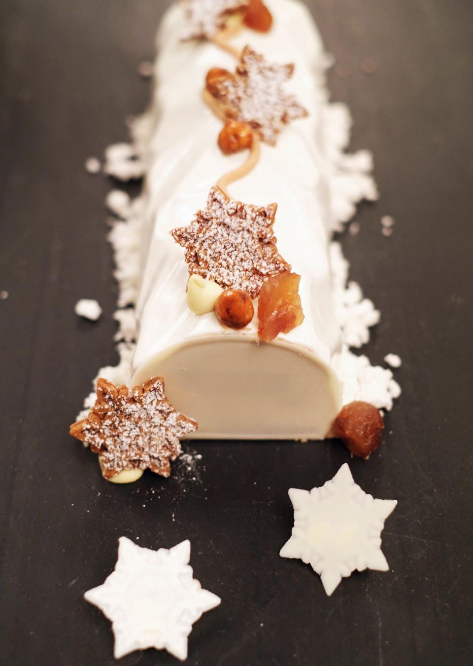 Three flavors of whole buche de Noel are offered to go by Cafe Boulud, including coconut and passionfruit.