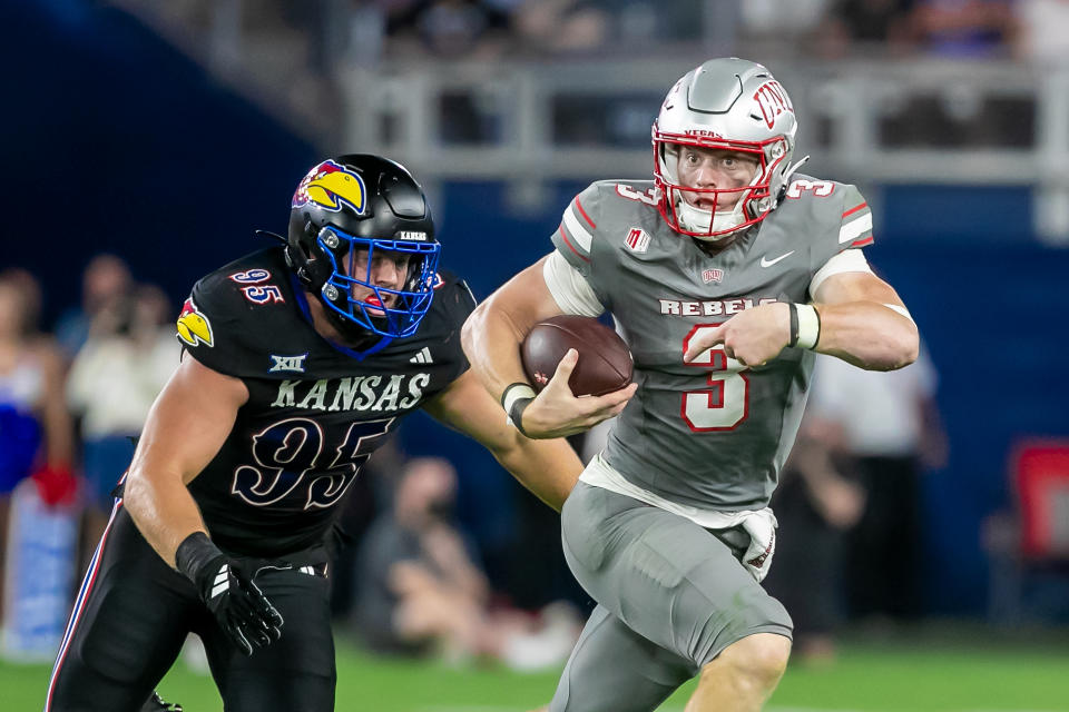 KANSAS CITY, KS - SEPTEMBER 13: UNLV quarterback Matthew Sluka (3) wrestles the ball past Kansas defensive end Dylan Wudke (95) during the game between the Kansas Jayhawks and the UNLV Rebels on Friday, September 13, 2024 at Children's Mercy Park in Kansas City, Kansas. (Photo by Nick Tre. Smith/Icon Sportswire via Getty Images)