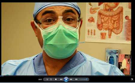 Sam Kazemi, a technician at Biological Resource Center in Phoenix, Arizona, is shown in a screen shot from a 2013 company training video in which he removes a dead man’s spine. Video by BRC via REUTERS