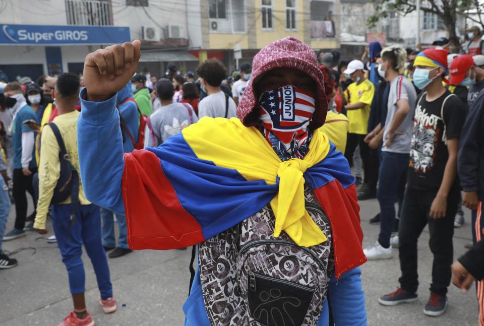 Anti-government demonstrators protest against the FIFA World Cup Qatar 2022 qualifying soccer match between Argentina and Colombia that will be played in Barranquilla, Colombia, Tuesday, June 8, 2021. (AP Photo/Jairo Cassiani)