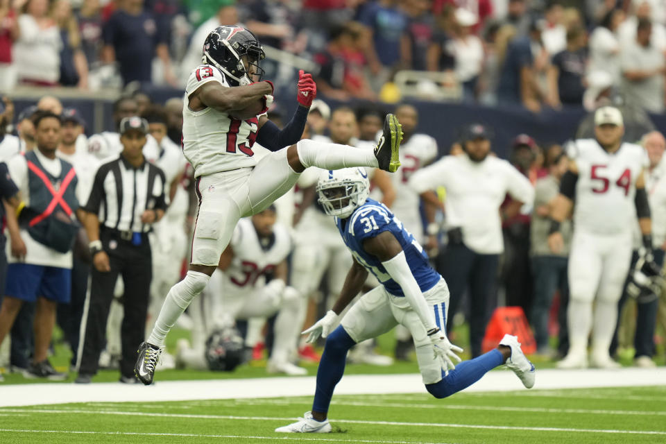 Houston Texans wide receiver Brandin Cooks (13) hauls in a pass in front of Indianapolis Colts safety Brandon Facyson (31) during overtime of an NFL football game Sunday, Sept. 11, 2022, in Houston. (AP Photo/Eric Christian Smith)