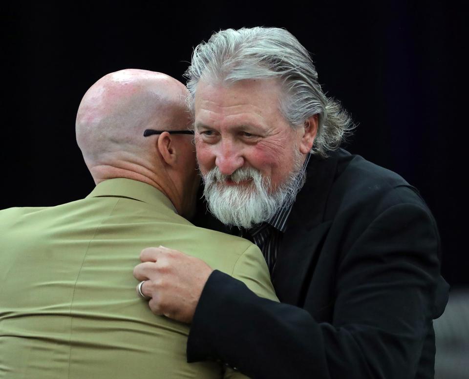 Former Zips basketball coach Bob Huggins, facing, hugs current coach John Groce after speaking during the Akron Basketball reunion and celebration at the University of Akron student union, Saturday, July 27, 2024, in Akron, Ohio.