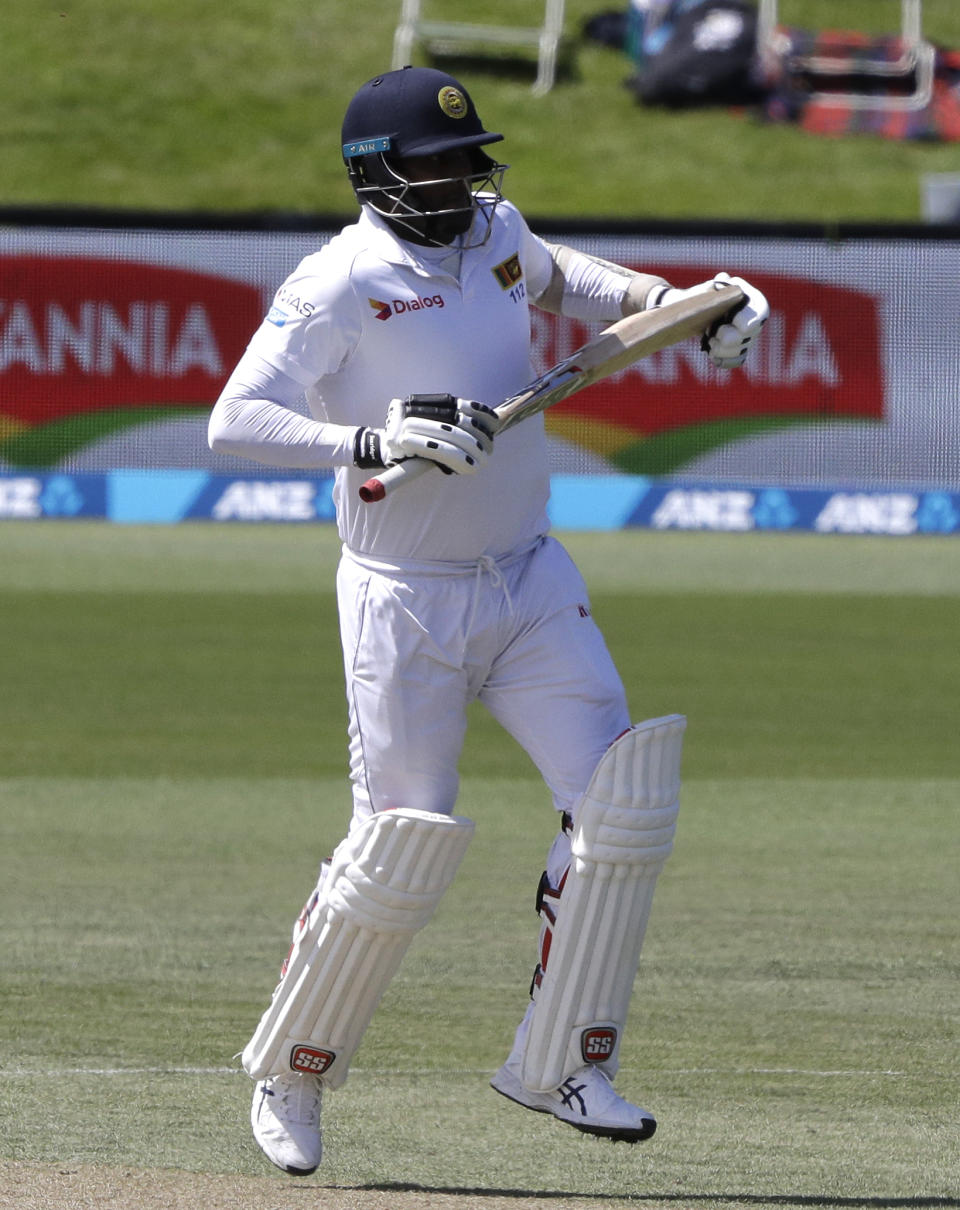 Sri Lanka's Angelo Mathews hobbles down the wicket after injuring his leg while batting during play on day four of the second cricket test between New Zealand and Sri Lanka at Hagley Oval in Christchurch, New Zealand, Saturday, Dec. 29, 2018. (AP Photo/Mark Baker)