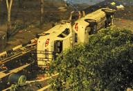 Two police cars flipped to their sides remain in the street after a riot broke out in Singapore, in the early hours of December 9, 2013