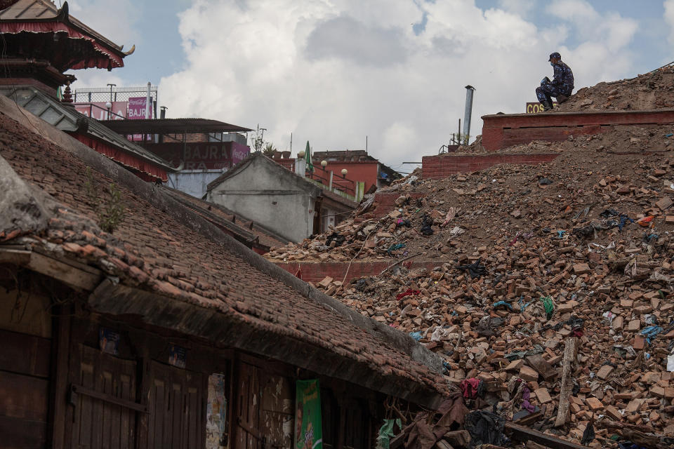 A rescue team member sits on top of the debris of a collapsed temple at Basantapur Durbar Square on April 27, 2015 in Kathmandu, Nepal.  (Photo by Omar Havana/Getty Images)