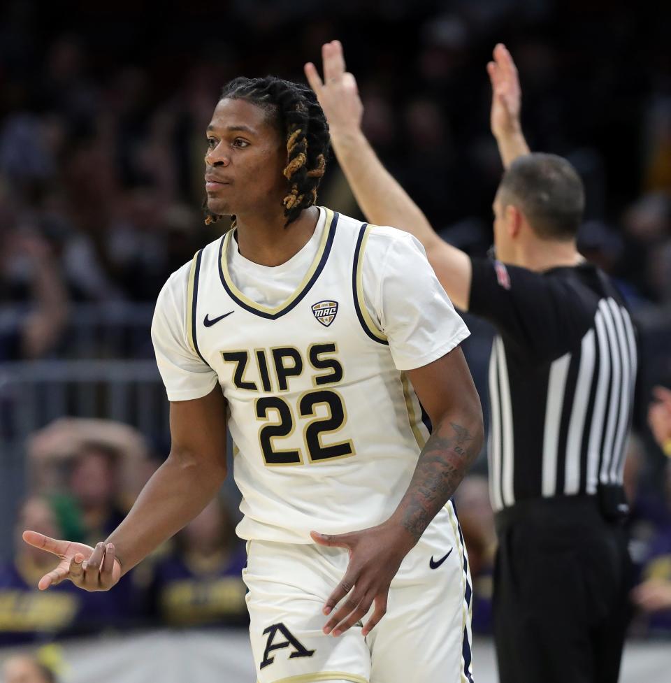 Akron Zips guard Mikal Dawson (22) celebrates after a three during the first half of the Mid-American Conference Tournament championship game at Rocket Mortgage FieldHouse, Saturday, March 16, 2024, in Cleveland, Ohio.