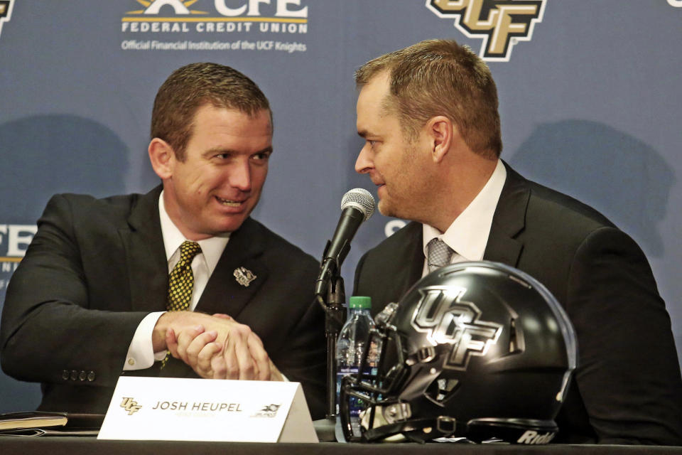 FILE - In this Dec. 5, 2017, file photo, Josh Heupel, right, is introduced as the new Central Florida head football coach by Danny White, UCF Athletic director, in Orlando, Fla. Josh Heupel is leaving UCF to become the next Tennessee coach, a person with knowledge of the situation told The Associated Press on Wednesday, Jan. 27, 2021. Tennessee hired Danny White away from UCF as its athletic director last Thursday, and his first job was finding a new football coach to replace Jeremy Pruitt, who was fired Jan. 18.(Red Huber/Orlando Sentinel via AP, File)