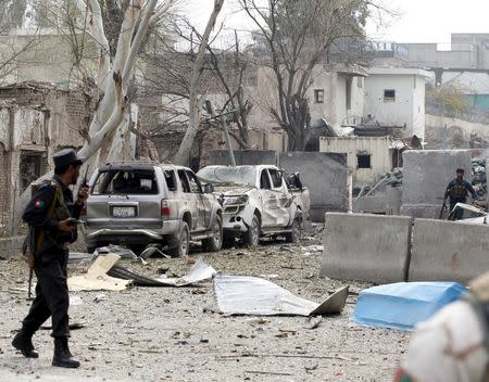 Afghan policemen take position during the gunfire in front of the Indian consulate in Jalalabad, Afghanistan March 2, 2016. REUTERS/ Parwiz