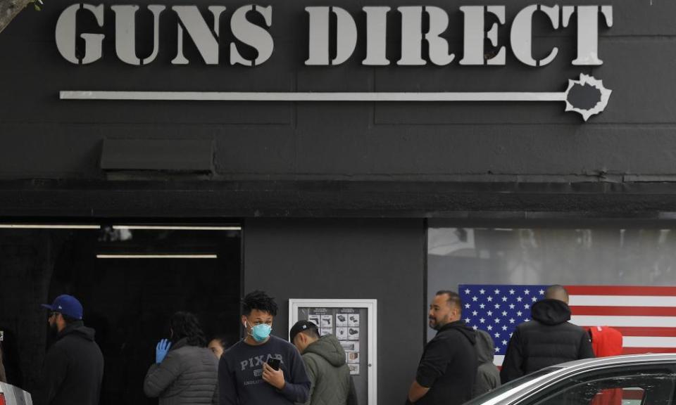 People wait in line outside a gun store in Burbank, California.