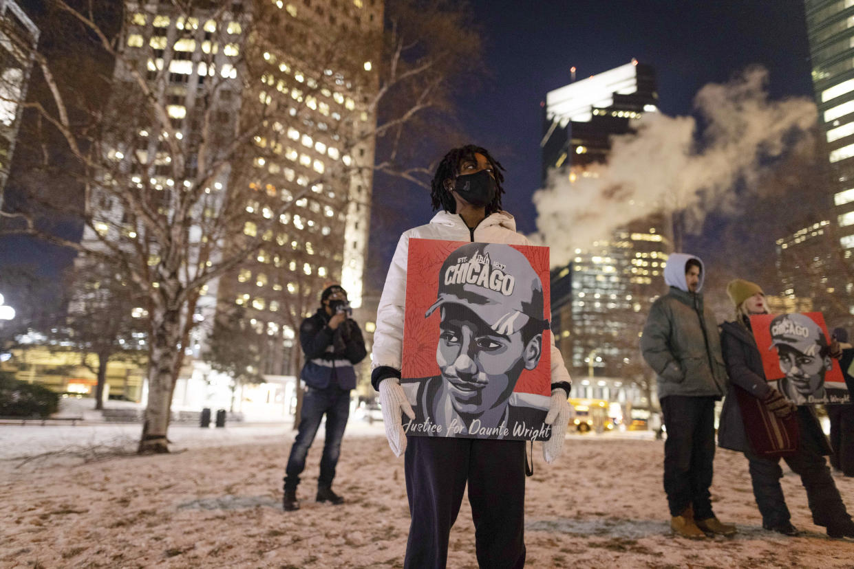 A protester holds a sign in support of Daunte Wright on the third day of jury deliberation outside of the Hennepin County Government Center on Wednesday, Dec. 22, 2021, in Minneapolis. Former Minneapolis police officer Kim Potter, who is white, is charged with first- and second-degree manslaughter in the shooting of Wright, a Black motorist, in the suburb of Brooklyn Center. Potter has said she meant to use her Taser – but grabbed her handgun instead – after Wright tried to drive away as officers were trying to arrest him. (AP Photo/Christian Monterrosa)