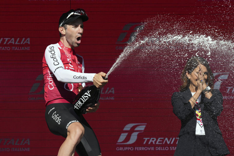 France's Benjamin Thomas celebrates on podium after winning the fifth stage of the Giro d'Italia, Tour of Italy cycling race, from Genoa to Lucca, Wednesday, May 8, 2024. (Gian Mattia D'Alberto/LaPresse via AP)