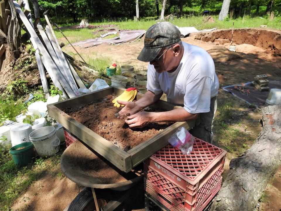 Amateur archaeologist Mark Hersman sifts through dirt in 2020 looking for artifacts from a Coshocton County site that once was a Native American village that spanned generations.