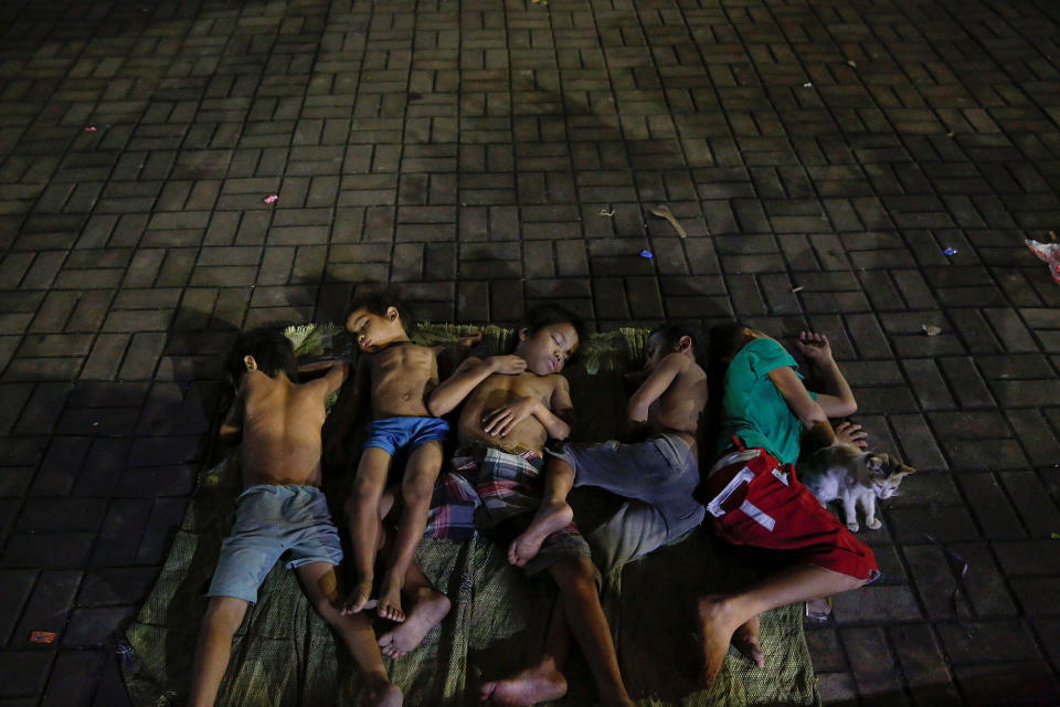 Children sleep on a square in Manila, Philippines