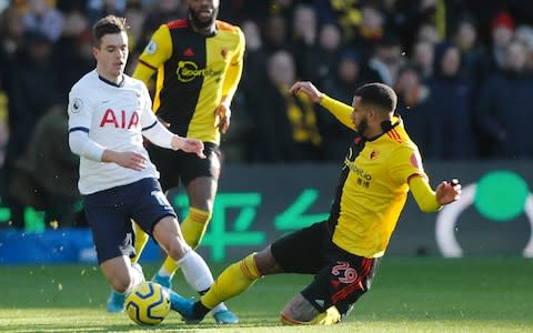 Tottenham's Giovani Lo Celso, left, is tailed by Watford's Etienne Capoue during the English Premier League soccer match between Watford and Tottenham Hotspur - Credit: AP