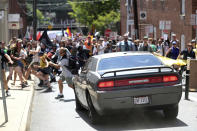 <p>A vehicle drives into a group of protesters demonstrating against a white nationalist rally in Charlottesville, Va., Saturday, Aug. 12, 2017. (Photo: The Daily Progress via AP) </p>