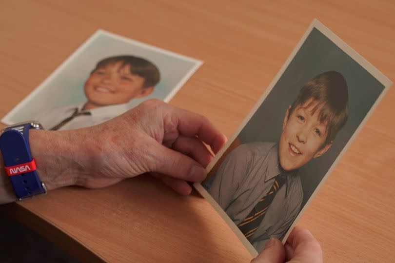 Yvonne holding a photo of Nick as a child