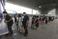 Visitors wearing face masks wait in line to buy tickets to enter an exhibition hall at the National Museum of Korea in Seoul, South Korea, Wednesday, July 22, 2020. The museum reopened Wednesday after having been closed for two months due to new coronavirus concerns. (AP Photo/Ahn Young-joon)