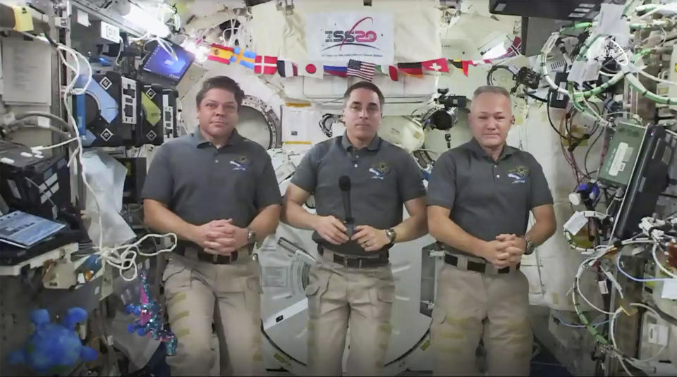 This photo provided by NASA shows from left, astronauts Bob Behnken, Chris Cassidy and Doug Hurley during an interview on the International Space Station on Friday, July 31, 2020. Behnken and Hurley are scheduled to leave the International Space Station in a SpaceX capsule on Saturday and splashdown off the coast of Florida on Sunday. (NASA via AP)