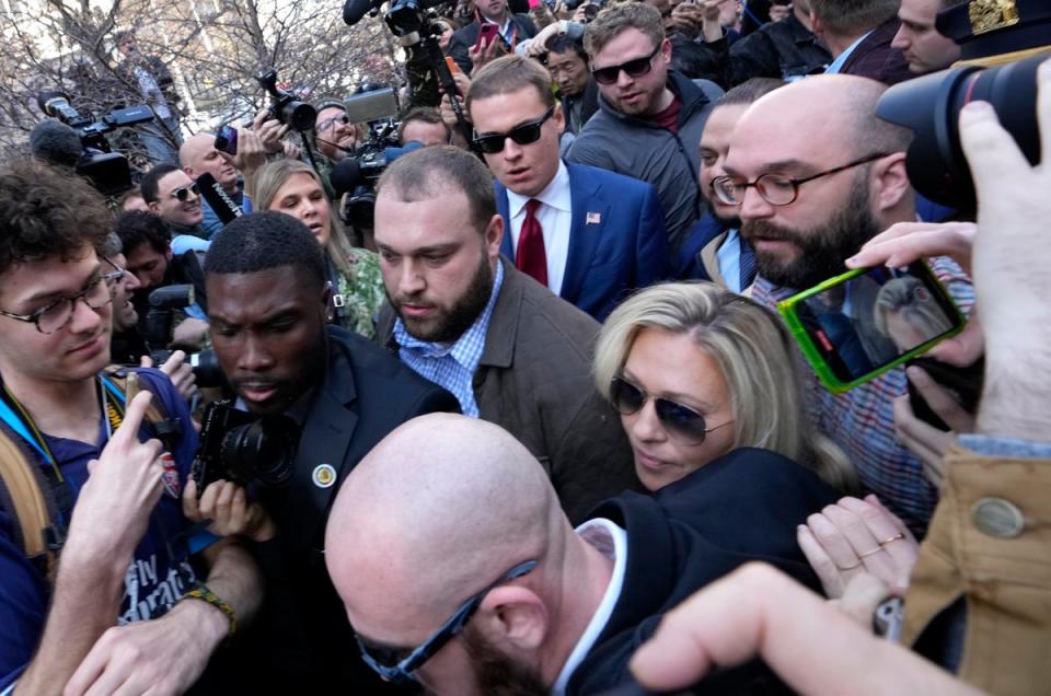 Marjorie Taylor Greene pushes through a crowd at a pro-Trump rally (Getty Images)