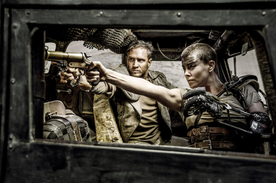 Charlize Theron and Tom Hardy pointing guns in a scene from the movie (Jasin Boland / Warner Bros. via Everett Collection file)