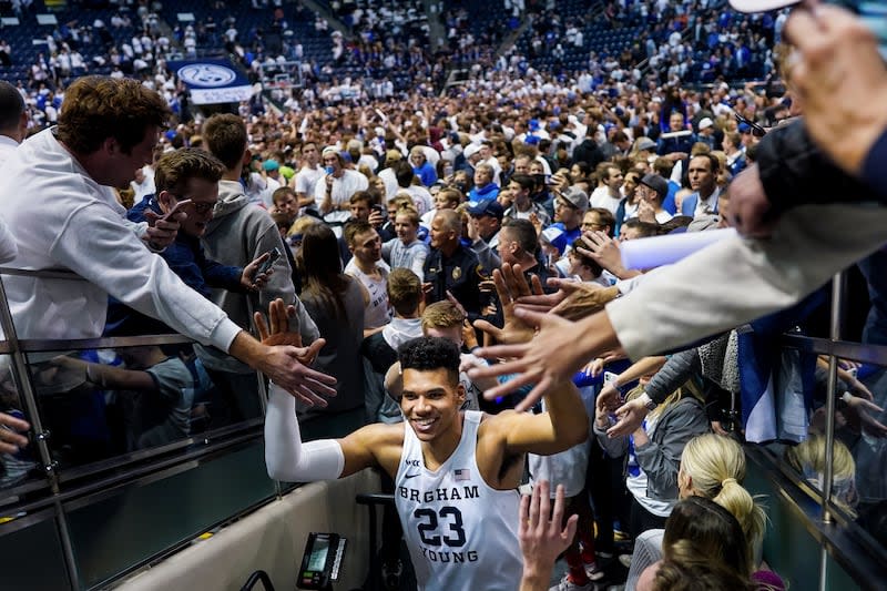 Brigham Young Cougars forward Yoeli Childs (23) celebrates with fans after BYU toppled No. 2-ranked Gonzaga 91-78 at the Marriott Center in Provo on Saturday, Feb. 22, 2020. | Spenser Heaps, Deseret News
