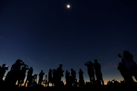 People watch the total solar eclipse from Clingmans Dome, which at 6,643 feet (2,025m) is the highest point in the Great Smoky Mountains National Park, Tennessee, U.S. August 21, 2017. Location coordinates for this image are 35º33'24" N, 83º29'46" W. REUTERS/Jonathan Ernst